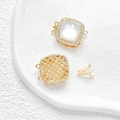 Macro detail of 14k gold plated square connector with white shell and pavé zircon stones - 18K Gold