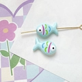 Macro shot of two light blue hand-painted fish beads for DIY jewelry making - Teal Style (10#)