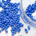 Macro shot of sky blue peanut-shaped double-hole seed beads for DIY jewelry making - Dark Blue