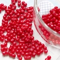 Detail of red peanut-shaped double-hole glass beads for DIY jewelry making and crafts - Dark Red