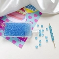 Macro view of 4mm light blue glass seed beads with storage box and threading needle - Light Blue