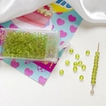 Macro detail of 4mm grass green frosted glass beads with a threading needle and storage box - Grass Green