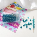 Detailed view of 4mm frosted lake blue glass seed beads with beading needle and organizer box - Lake Blue
