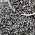 Close-up of shiny silver metallic glass bugle beads for handmade jewelry weaving - Style 7