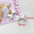 Macro detail of bone-shaped pearl white beads with 18mm by 12mm size markers - Pearl White Bone Style