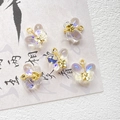 Macro detail of five iridescent butterfly charms with gold metal loops on calligraphy paper - Iridescent Transparent Butterfly Style (D4422-2)