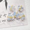 Close-up of translucent blue butterfly charms with gold metal loops for DIY jewelry - Light Blue Butterfly Style (D4422-4)