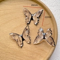 Close-up of butterfly pendants with vintage calligraphy and size details on wood tray - 13# No-hole Calligraphy