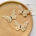 Detailed view of three butterfly DIY pendants with Chinese calligraphy on wood tray - 5# Ancient Script