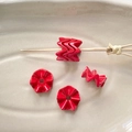 Macro detail of red wavy acrylic beads on ceramic tray for DIY jewelry making - Red