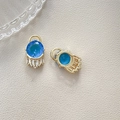 Close-up of gold-plated evil eye pendant with blue gemstone and zircon tassel details - Blue Round Fringe (4#)