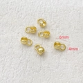 Detailed view of 14k gold plated 4mm and 6mm clamshell bead tips for DIY jewelry making - Gold