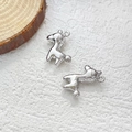 Detailed close-up of a silver deer pendant for DIY jewelry on a natural wood base - Pony (White Gold)