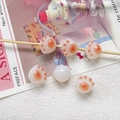 Detailed view of cute resin cat paw beads for DIY jewelry and handmade crafts accessories - 10 Pieces Pack / Orange Red