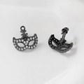 Detail of gunmetal black mask earrings with micro-paved cubic zirconia and flower studs - Gunmetal