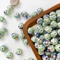 Macro shot of kiln-fired glazed ceramic pumpkin beads for DIY handmade jewelry crafting - Green Blue Red Kiln Glazed Style (2#)