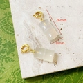 Detail view of 26mm natural agate bamboo pendant with gold loop on marble surface - Bamboo Design Style
