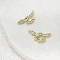 Macro detail of gold-plated lava style connectors with triple loops on a white stone tray - 14k Gold 4-Ring Molten Lava Connector Rod (2#)