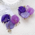 Macro detail of purple organza flower earrings with crystal beads and white pearls - Flower Shape Accessory / Purple