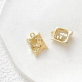 Macro detail of 18k gold plated textured dragon charms with cubic zirconia and smooth frame - Rectangle Texture Shape / 18K Gold