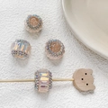 Vue détaillée de quatre perles en cristal rose iridescent avec strass pour bijoux DIY - Rose Clair Style 5