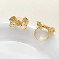Macro view of 18k gold plated bow ring settings with sparkling zircon accents - 18k Gold Style / Gold