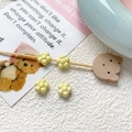Detailed view of four mini yellow resin flower beads for DIY jewelry making and crafts - Yellow Flower (21#)