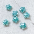 Macro view of blue ceramic clover beads with threading hole for DIY jewelry making - 10# Gradient Lake Blue Flower