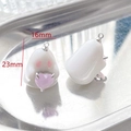 Macro detail of acrylic ghost pendant with pink heart gemstone and 23mm size label - Ghost with Pink Heart Style