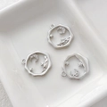 Macro shot of silver crescent moon and star charms with cubic zirconia inlay details - Platinum Plated Moon Star Style