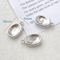 Detailed view of silver oval bean pendants with 18mm length and smooth mirror finish - Oval Bean Style