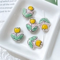 Macro shot of hand-painted ceramic tulip beads for DIY jewelry making in a white tray - Pink Yellow