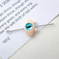 Detailed close-up of a funny monster cat jewelry charm with a blue eye inlay and silver pin - 3# Beige Single Eye Monster (D4171)