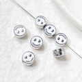 Detailed view of smiley face enamel beads on a thin wire for DIY jewelry making - Platinum