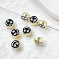 Macro detail of gold plated smiley face beads for DIY jewelry making and bracelets - 16# K Gold Tone
