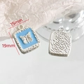 Detailed macro of 15x19mm light blue enamel heart pendant with silver butterfly relief - Square Butterfly Embossed - Blue (6#)