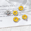 Detail view of donut-shaped alloy pendants with yellow enamel on a decorative background - Silver Yellow Donut (3# Silver Single Price)