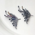 Macro detail of wing earrings featuring colorful cubic zirconia on dark plated metal base - Gun Black Pair