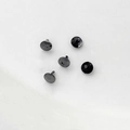 Detail of five black 18k gold-plated pearl plug caps with smooth polished finish - Gunmetal