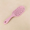 Pink vented detangling brush with scalp massaging bristles and a hanging hole handle - Pink