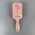 Detail of pink marble hair brush featuring floral pattern and customized Emily name - Pink Marble Floral Print