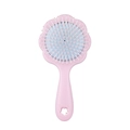Pink flower-shaped air cushion hairbrush with white bristles and blue pad on white background - Pink