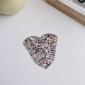 Close-up of heart-shaped acetate hair comb featuring premium brown marble texture finish - Marble