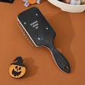 Detail of Halloween air cushion hairbrush with white spider web and spider pattern on black - Spider