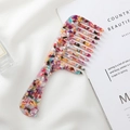 Wide-tooth acetate hair comb with a colorful marble texture and ergonomic handle design - Rainbow