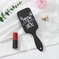 Detail of black hair brush featuring a cute cartoon cat design and ergonomic handle - Custom Pattern / Little Mouse