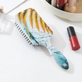 Detail view of marble pattern cushion hairbrush on white desk with beauty accessories - Gold Leaf Marble