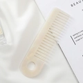 Close-up of cream marble pattern hair comb with wide teeth and round hanging hole design - 15.1x4cm / Mermaid Color