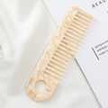 Macro detail of marble pattern acetate wide-tooth comb on silk with elegant texture - 15.1x4cm / Yellow Marble Pattern