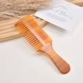 Amber acetate dual-sided hair comb with wide and fine teeth on a wooden tray - Caramel color